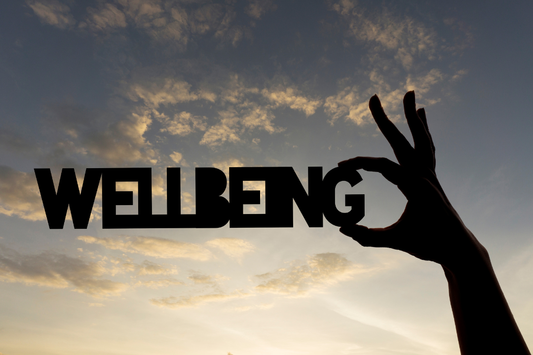 Wellbeing image in the sky with a hand